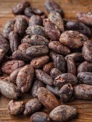 a pile of peanuts sitting on top of a wooden table