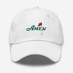 This Masters hat is simple and classic and ready to be worn at the Masters Golf tournament. This golf hat is an Embroidery that you can wear to watch this Golf tournament at Augusta.  The Masters is coming soon... make sure you get yourself a hat to support one of the greatest golf tournaments in the world. This classic design comes in various colors to match your outfit on Masters sunday! The design is embroidered into the hat/cap. * 100% chino cotton twill * Green Camo color is 35% chino cotton twill, 65% polyester * Unstructured, 6-panel, low-profile * 6 embroidered eyelets * 3 ⅛" (7.6 cm) crown * Adjustable strap with antique buckle * Blank product sourced from Vietnam or Bangladesh Masters Hat, Golf Embroidery, Golf Masters, The Masters Golf, Masters Golf Tournament, Masters Tournament, Masters Golf, Long Sleeve Baseball Tee, Custom Tank Tops