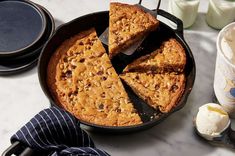 a cake in a pan with one slice cut out and the other half on a plate next to it