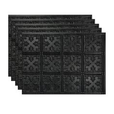 four black decorative tiles on a white background