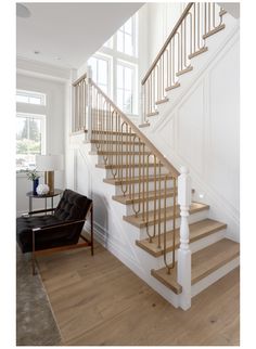 a living room with a couch, chair and stairs