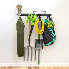 there is a rack with gardening tools on it