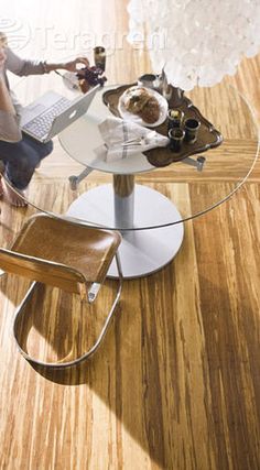 an image of a table and chairs with wood flooring in the background, text reads create with tergann