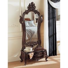 an ornately carved wooden vanity with mirror