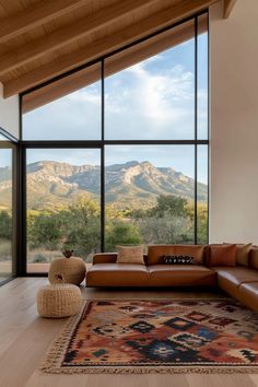 a living room with large windows overlooking mountains