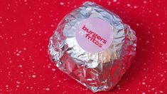 a piece of tin foil sitting on top of a red surface