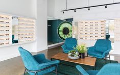 an eyeglass store with blue chairs and tables