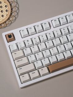 a white computer keyboard sitting on top of a table