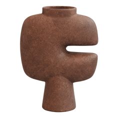 a brown vase sitting on top of a white surface