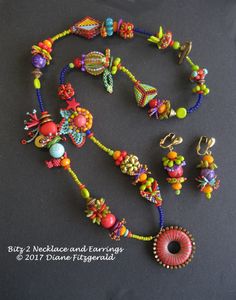 an assortment of colorful beaded jewelry on a black surface