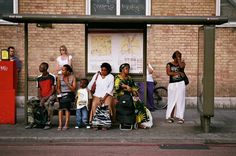 a group of people waiting at a bus stop