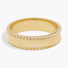 a gold ring with braiding on it