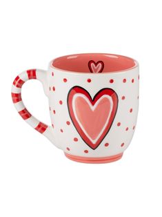 a red and white coffee cup with hearts on it