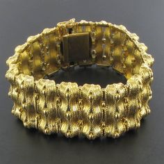 This is part of Chairish’s Fine Jewelry assortment.  18 carat yellow gold bracelet, rhinoceros head hallmark.  Fully articulated, this splendid bracelet is formed of articulated motifs made of ribbons of chiseled gold spaced with small golden pearls.  The clasp is with 8 safety.  Length: 18.5 cm, width at widest: 2.7 cm, thickness at widest: 5.9 mm.  Total weight of the bracelet: 71.2 g approximately.  Authentic antique jewel-French work from the end of the 19th century.  Our opinion: Rare of th