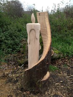 a carved wooden sculpture sitting on top of a tree stump