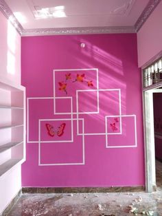 a pink wall with white squares and butterflies painted on it