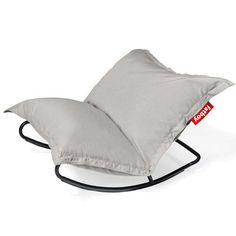 a rocking chair with a pillow on it's back and the seat cushion folded down