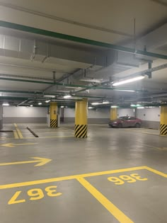 an empty parking garage with yellow lines painted on the floor