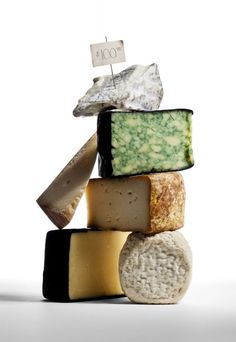 several different types of cheese stacked on top of each other