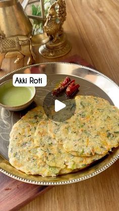 a metal plate topped with food on top of a wooden table