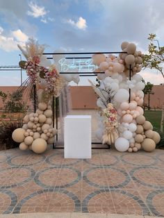 an arch made out of balloons and flowers