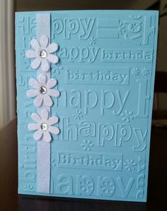 a blue card with white flowers on it