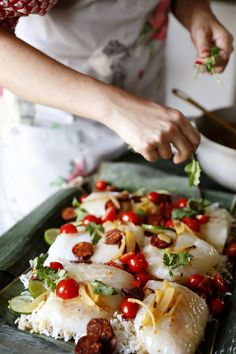 a woman is preparing food on a tray