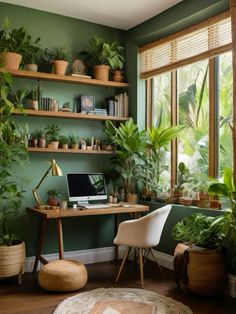 a home office with green walls and lots of plants