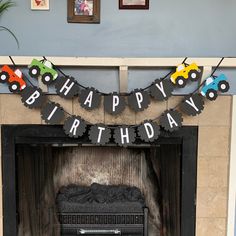 a happy birthday banner hanging over a fireplace with a toy truck on it's mantle