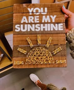 someone is holding up a sign that says you are my sunshinene with string art on it