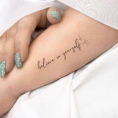 a woman's arm with a tattoo that reads, believe in yourself