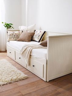 a white daybed with storage drawers and pillows on the top, next to an image of a bed