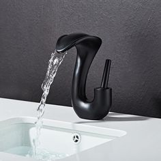 a black sink faucet with water running from it