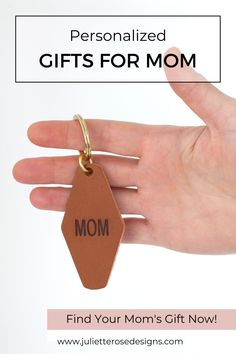 a woman's hand holding a brown leather keychain with the words, personalized gifts for mom