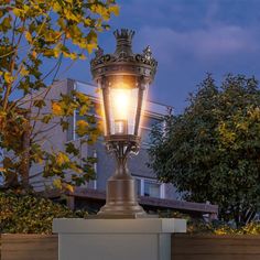 an old fashioned street lamp lit up at night