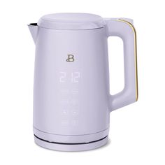 the electric kettle is white and has gold trimmings