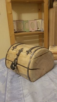 a wooden trunk sitting on top of a bed