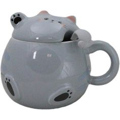 a gray ceramic cat mug with its eyes closed