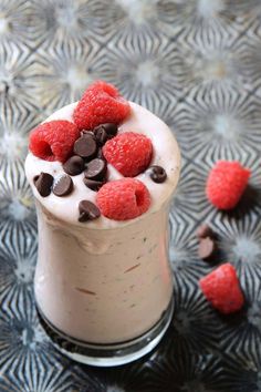 a dessert with raspberries and chocolate chips in it on top of a table