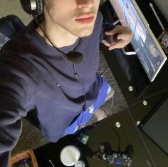 a young man wearing headphones while using a computer