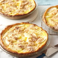 three pies sitting on top of a white table