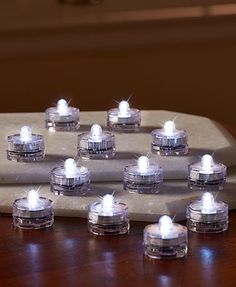 a bunch of white lights sitting on top of a wooden table