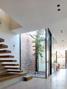 an open floor plan with stairs leading up to the upper level and glass doors on both sides