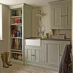 a kitchen filled with lots of green cupboards