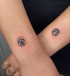 two people with matching tattoos on their arms