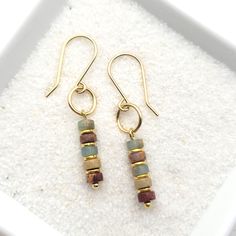 "Minimalist style with these 14k gold filled earrings with Aqua Terra jasper beads * Earrings are made from quality 14k gold filled wire, they measure approximately 1.5\" in length.   * Polished to a high shine * Sent in a Gift Box with Polishing Cloth * Handmade in Montana ----- OUR MATERIALS -----  *STERLING SILVER - Experience the elegance of Sterling Silver, a metal that combines versatility with a sophisticated look. This durable and lightweight alloy is perfect for everyday wear, offering Gold Bead Earrings, Beaded Earrings Diy, Aqua Terra, Western Earrings, Gold Dangle Earrings, Earrings Inspiration, Homemade Jewelry, Gold Filled Earrings, Jasper Beads