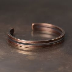 Hand-crafted double banded oxidised pure copper bangle for men. Material: Copper Width: 8mm / 0.3". Lengths: 15 to 18cm, 19 to 22cm / 5.9" to 7.1", 7.4" to 8.6". Adjustable. Adjustable Brown Copper Bangle, Brown Copper Bracelet With Patina, Brown Copper Patina Bracelets, Brown Copper Bangle, Bangle For Men, Camping Knots, Wolfram, Ring Pendant Necklace, Watch Necklace