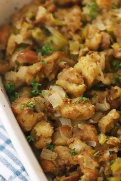 a casserole dish filled with stuffing and vegetables