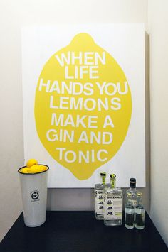 there is a lemon on the wall next to bottles