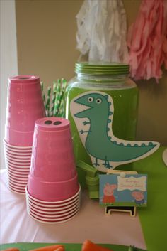 a table topped with plates and cups filled with carrots next to a mason jar